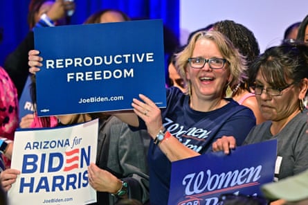 Women hold signs as they wait for Vice-President Kamala Harris to speak on reproductive freedom at El Rio Neighborhood Center in Tucson, Arizona, on Friday.