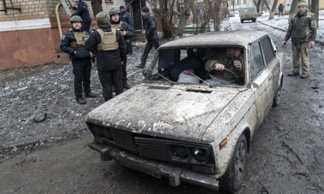 A Ukrainian soldier drives a damaged car after Russian missile strikes in Kramatorsk, Donetsk.