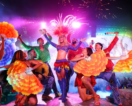 Karol G on stage in colourful outfit