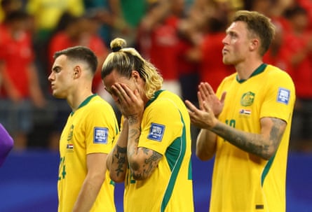 Australia’s Paul Okon Engstler, Jackson Irvine with his head in his hands, and Harry Souttar look dejected after being eliminated from the World Cup