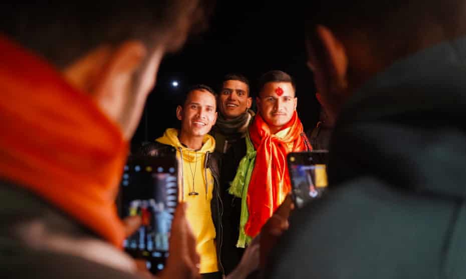 Nepalese men say goodbye to friends and family outside Kathmandu’s international airport before heading to jobs in the Gulf.