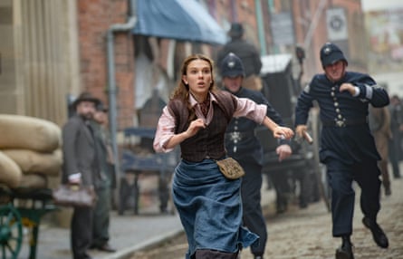 She runs down a London street with costermongers etc, being pursued by a Victorian copper