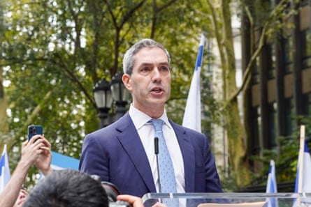 a man in a suit speaks into a microphone