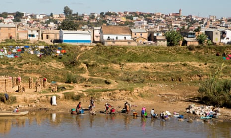 Women wash clothing in a polluted river in Madagascar’s capital, Antananarivo