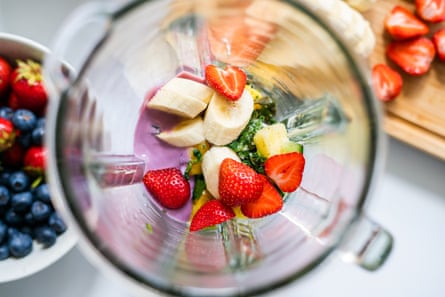 Top view of cut fruits and berries in a blender