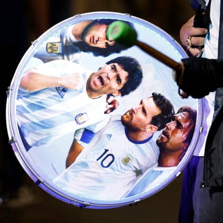 An Argentina fan bangs on a drum featuring Mario Kempes, Diego Maradona, Lionel Messi and Gabriel Batistuta outside the ground before their quarter-final against the Netherlands.