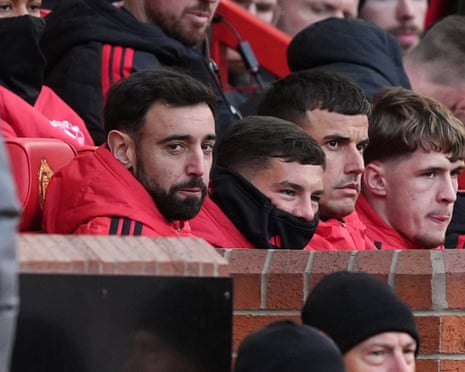 The Manchester United captain, Bruno Fernandes, sits on the bench after not being selected for his team's home Premier League game against Bournemouth.