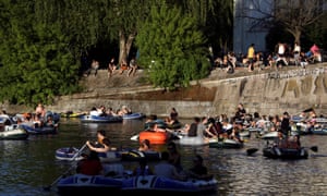 People enjoy sun on boats, on the Landwehrkanal, amid the spread of the coronavirus disease, in Berlin