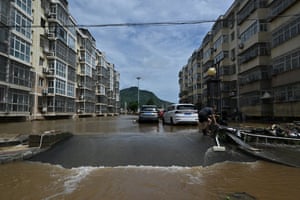 A man examines the aftermath of the floods in an inundated neighbourhood in Miyun district, northern Beijing.