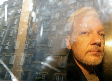 Buildings are reflected in the window as WikiLeaks founder Julian Assange is taken from court.