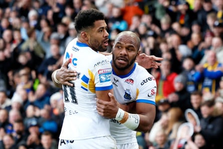 Maika Sivo and Kallum Watkins celebrate a try for Leeds against Warrington.