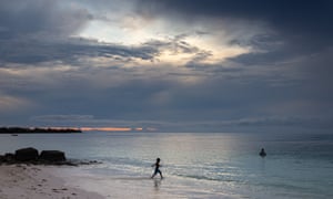 A young boy plays in the shallows of the Funafuti lagoon, Tuvalu
