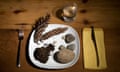 A dinner plate filled with rocks, soil and pine comes