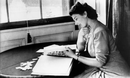 Elizabeth looking at a stamp album in the 1950s.