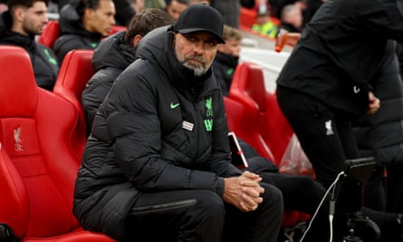 Jürgen Klopp sitting on a red chair in a stadium