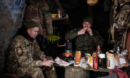Ukrainian servicemen eat in a hut at a rear-echelon location.