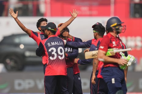 Nepal’s Nandan Yadav, left, celebrates the wicket of England’s Jos Buttler