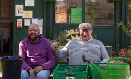 George Melrose, 81, and a volunteer, sitting side by side, at Balsall Heath city farm.