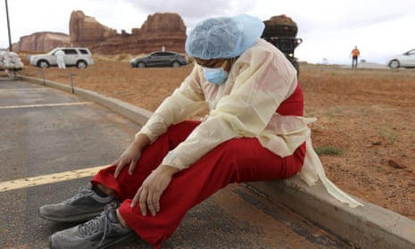 A Navajo health worker takes a brief break as vehicles line up for Covid-19 testing outside of the Monument Valley health center in Utah last month.