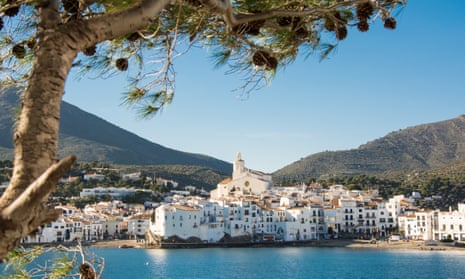 The whitewashed town of Cadaqués, with sea and green hills