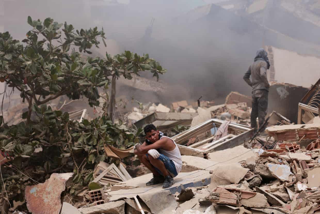 A man reacts amid the rubble of a building after earthquakes hit the country,