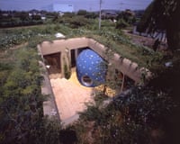 Image of the Soft and Hairy house, built in Tokyo in 1994 by Ushida Findlay Architects, with a blue blob-shaped bathroom encroaching on central open space surrounded by greenery