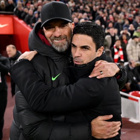 Jurgen Klopp manager of Liverpool embraces Mikel Arteta manager of Arsenal ahead of their Premier League match at Anfield.
