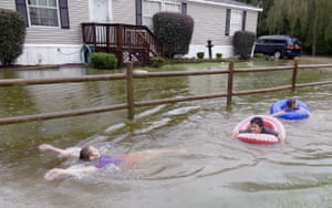Children play in floodwaters near Conway, South Carolina