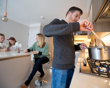 British family using gas cooker at home.