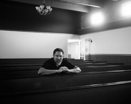 Man sitting on a pew in a funeral home