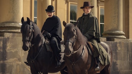 Two men on horses outside a monumental stone building