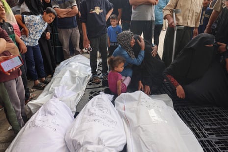 Palestinians mourn by the bodies of relatives killed in Israel’s bombardment at the al-Najjar hospital in Rafah in the southern Gaza Strip on 25 April.