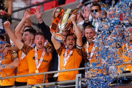 Hull's captain Lewis Coyle receives the trophy.