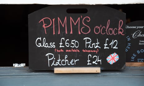 A Pimms O'Clock sign outside a pub in Henley. The town of Henley on Thames in Oxfordshire in June.