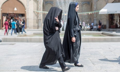 Two women walk over the Imam square in Isfahan, Iran. 