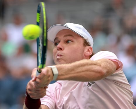 Alex Michelsen lunges to hit a backhand shot during a US Open match