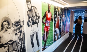 The Olympic Games: Mirror of Societies exhibition wall featuring blown-up pics of athletes over the decades