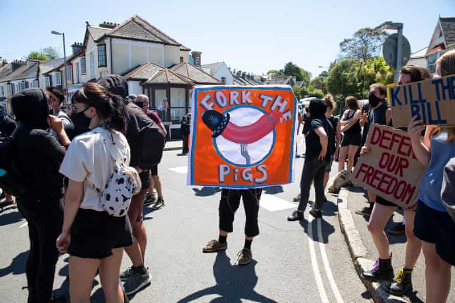 A banner saying 'fork the pigs' at the protest in Falmouth