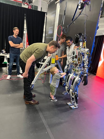 Elon Musk’s son X shakes hands with a Tesla Optimus robot in September 2022