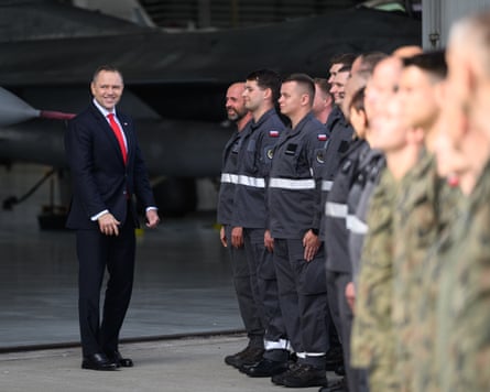Nawrocki beside a line of troops