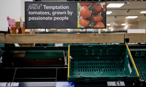 Empty shelves of fresh tomatoes are seen in a Tesco supermarket in London.