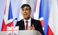 Rishi Sunak speaking at a lectern in front of union jack flags