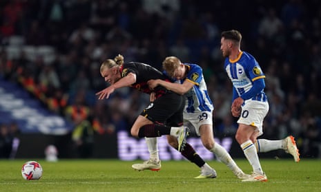 Manchester City's Erling Haaland is fouled by Brighton and Hove Albion's Jan Paul van Hecke.