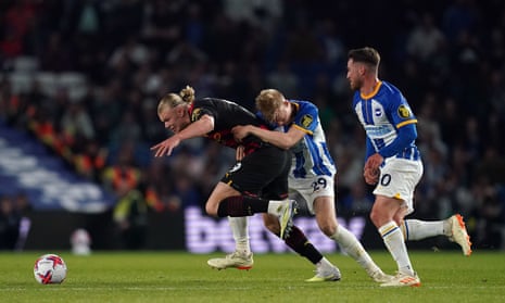 Manchester City's Erling Haaland is fouled by Brighton and Hove Albion's Jan Paul van Hecke.
