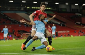 Raheem Sterling goes down under pressure from Harry Maguire.