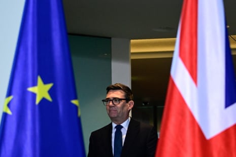 Burnham pictured between the EU flag and Union Jack.
