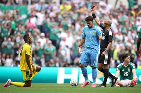 Referee Wilton Sampaio shows a red card to Sphephelo Sithole of South Africa.