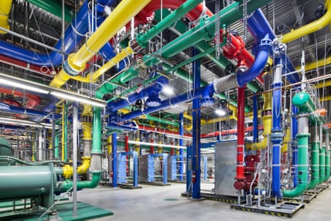 yellow, green, red and blue tubes on ceiling connecting to floor in a grey room