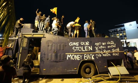 Protesters stand on a vandalised police truck at the entrance to the president's official residence in Colombo, Sri Lanka, last weekend