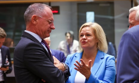 The German interior minister, Nancy Faeser and Austrian interior minister, Gerhard Karner, speak with each other at the start of a justice and home affairs council meeting in Brussels, Belgium.